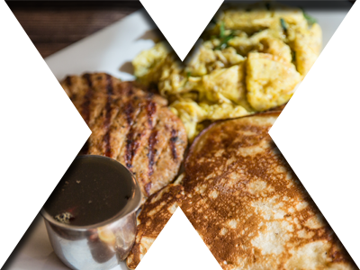 Classic Canadian breakfast with eggs, pancakes, and two turkey sausages