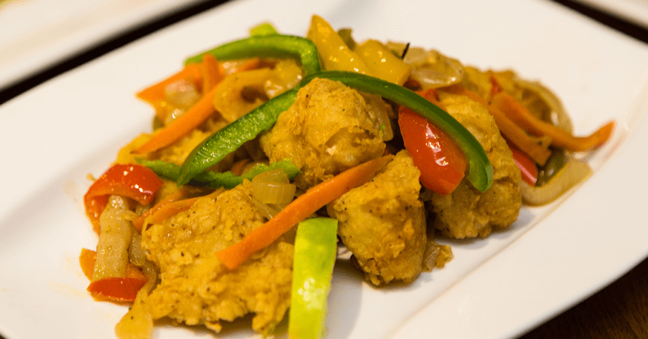Bite-sized, Jamaican-style crispy Escovitch fish with pickled onions and peppers