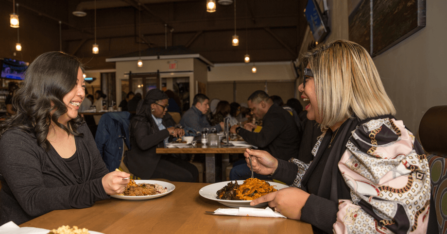 Friends sharing a delicious meal at a popular restaurant