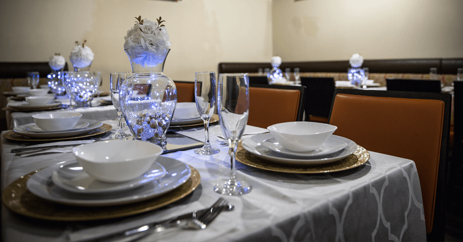 Elegant table setup for a private event with plates, silverware, and glassware