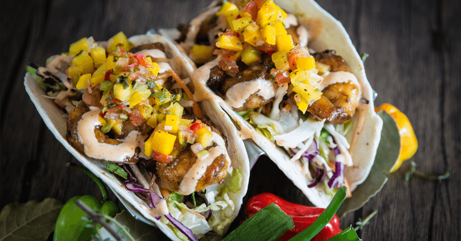 Fresh and vibrant jerk shrimp tacos topped with mango salsa and aioli sauce