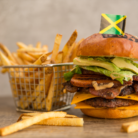 Yah Mon beef burger with cheddar, plantain, lettuce, avocado, jerked bacon, and aioli – thumbnail view