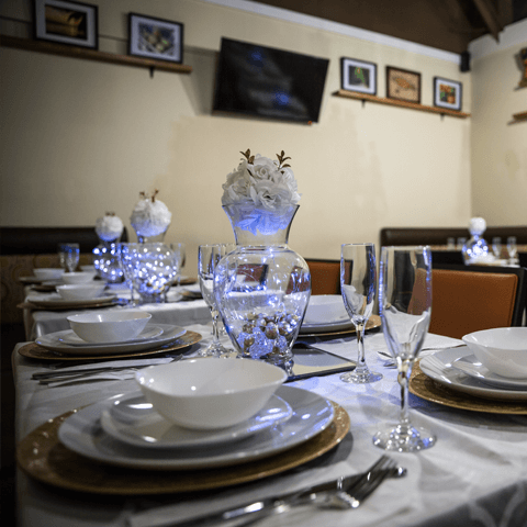 Private event table setup with elegant plates, silverware, and glassware – thumbnail view
